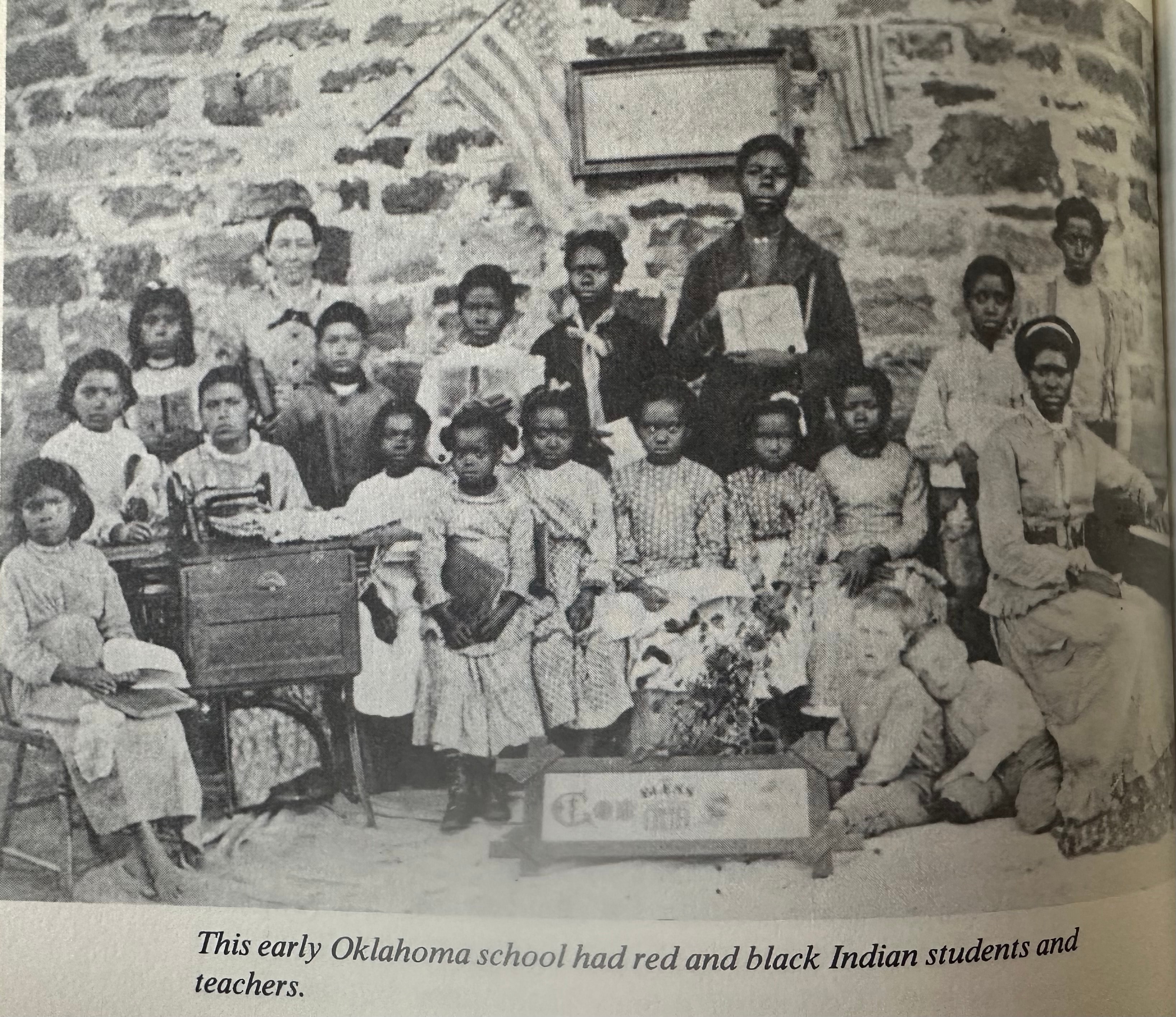 Historical black-and-white photograph of students and teachers at an early Oklahoma school