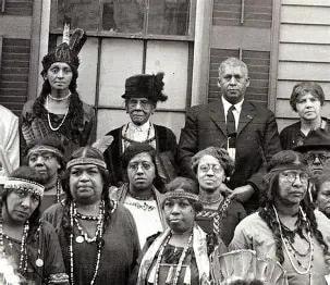 Historical group portrait of Indigenous North Americans in traditional regalia and dress
