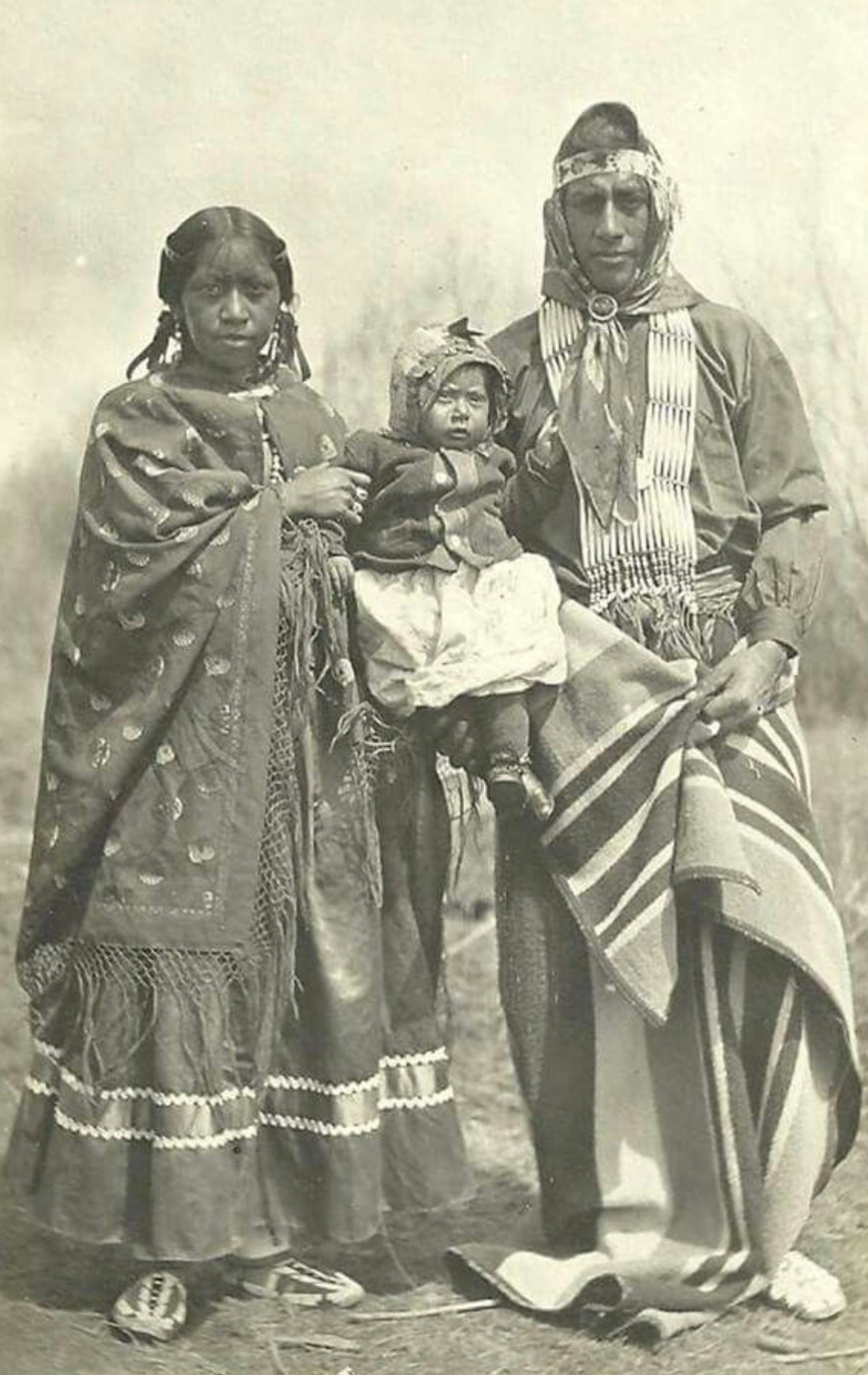 Mestizo family — possibly Caddo Nation, Texas — husband, wife, and infant in traditional dress, c. late 1800s