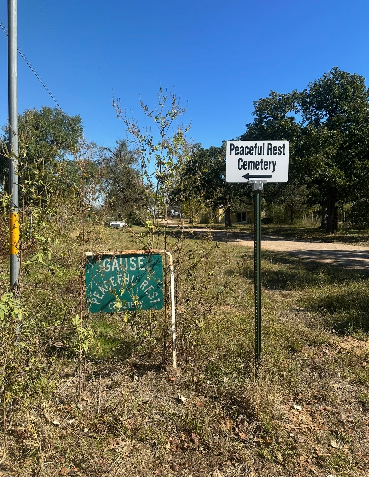Open dirt road with utility poles running through Gause, Texas — Cox's Freedom Colony corridor