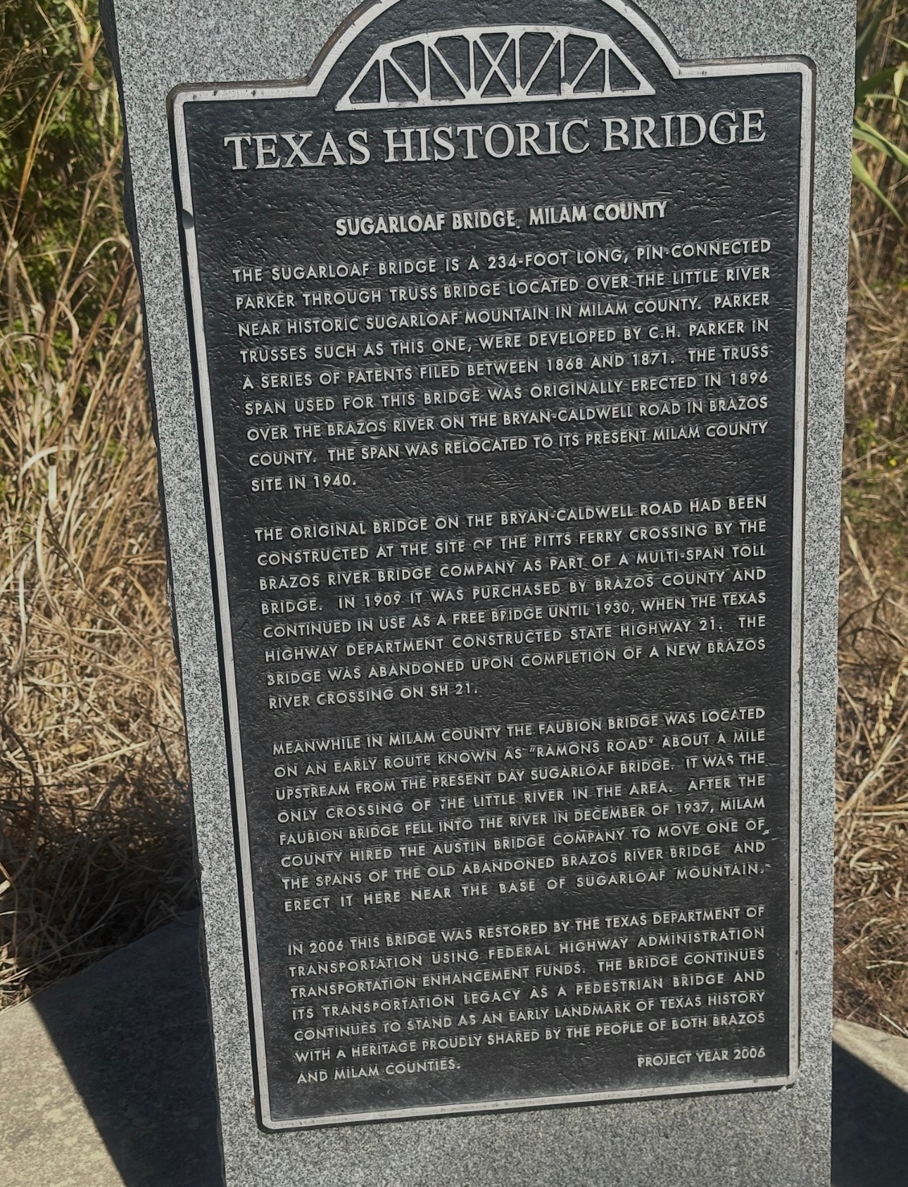 Family members at Sugarloaf Mountain markers in Milam County, Texas