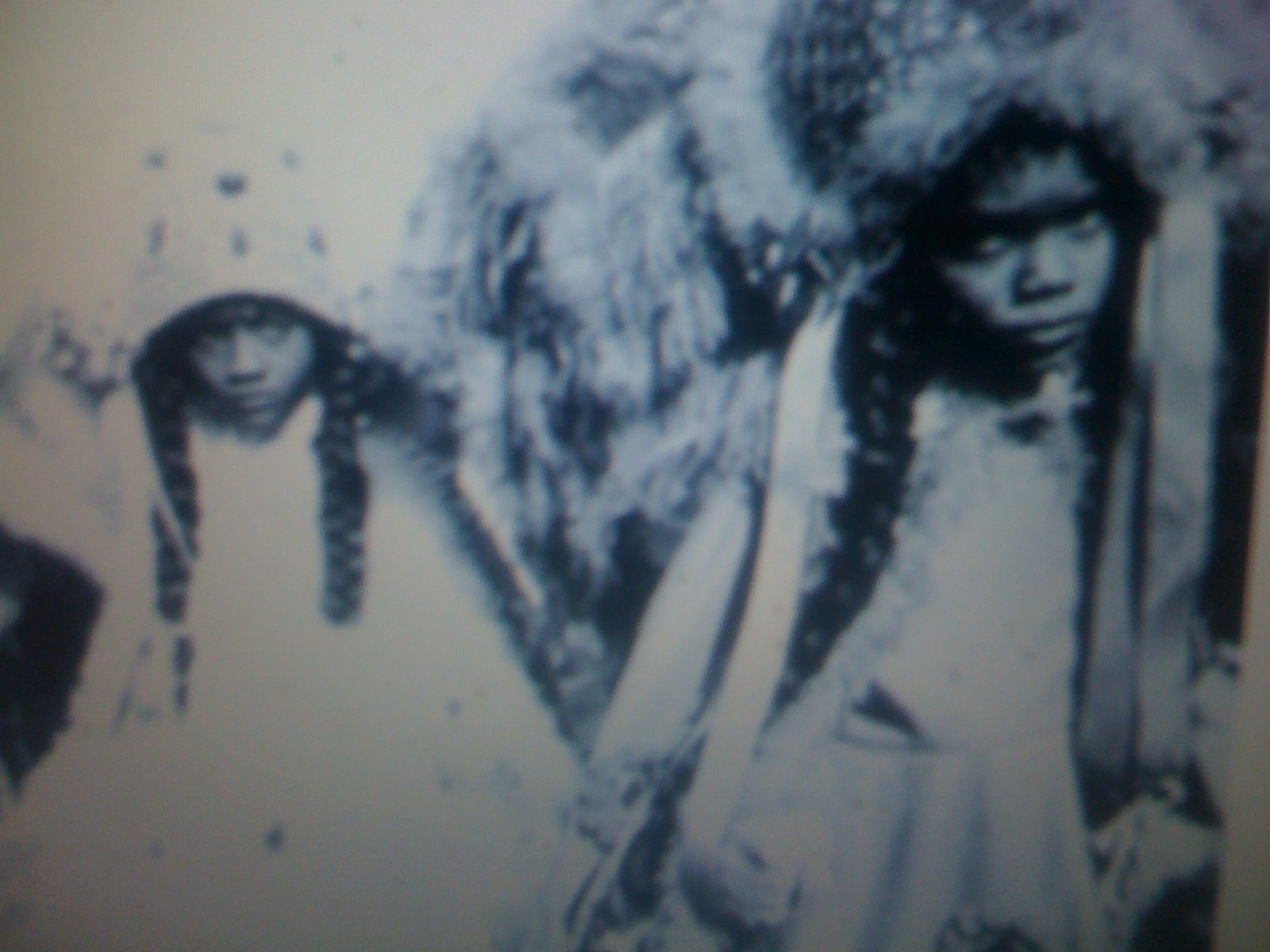 Indigenous North American girls with braids in winter clothing
